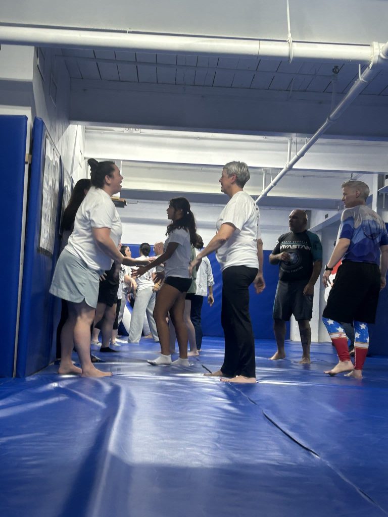 Participants practice together during a women’s self-defense seminar at North Georgia Hayastan MMA Academy in Dalton, Georgia