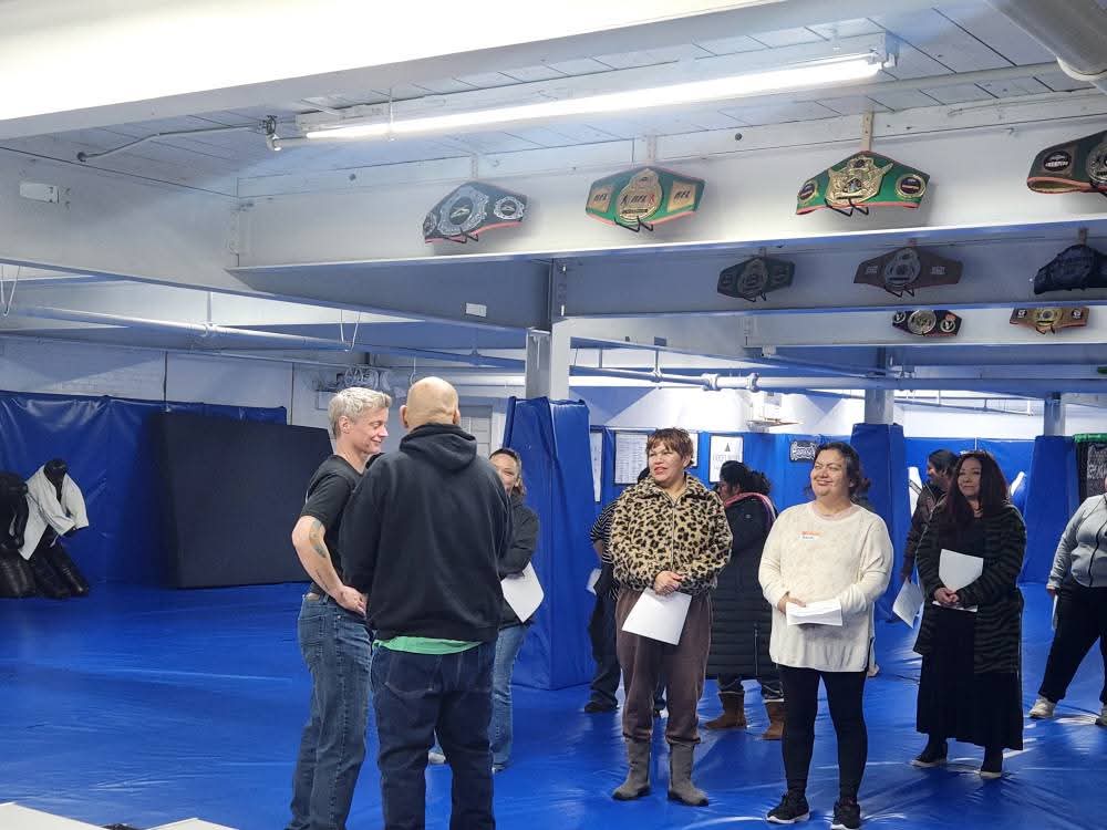 Participants gathered around Leonardo Lechuga during the women’s self-defense seminar