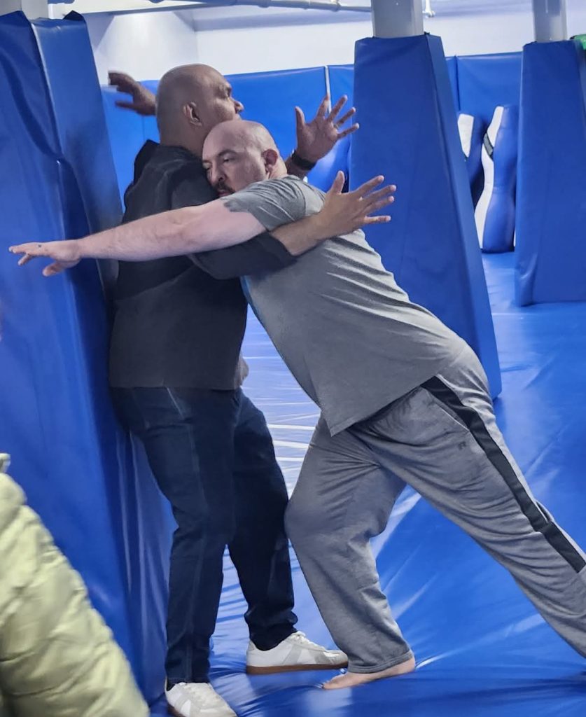 Demonstrating how to escape from being pinned against a wall