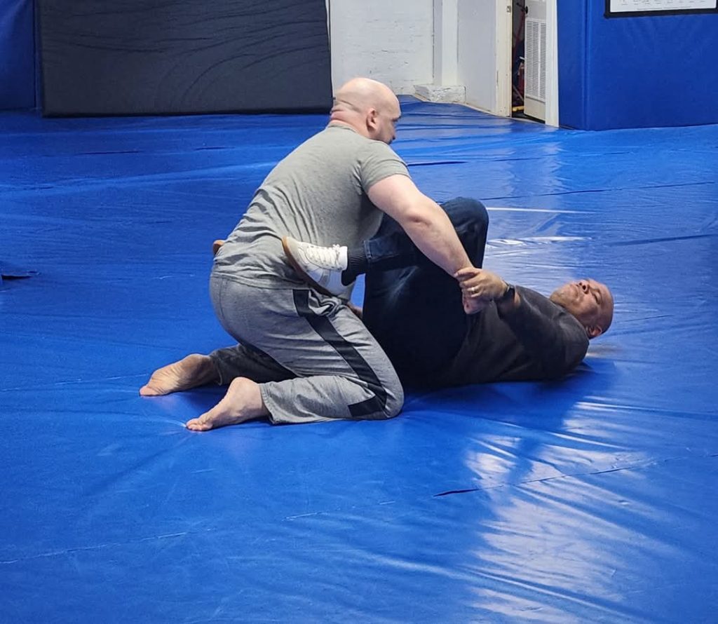 Demonstrating ground defense, using frames and legs to create space