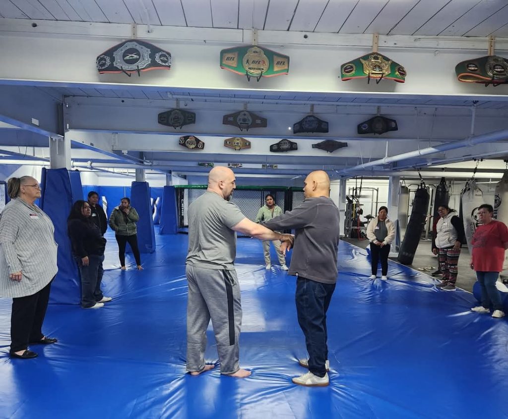 Instructors demonstrating wrist control in the center of the mat